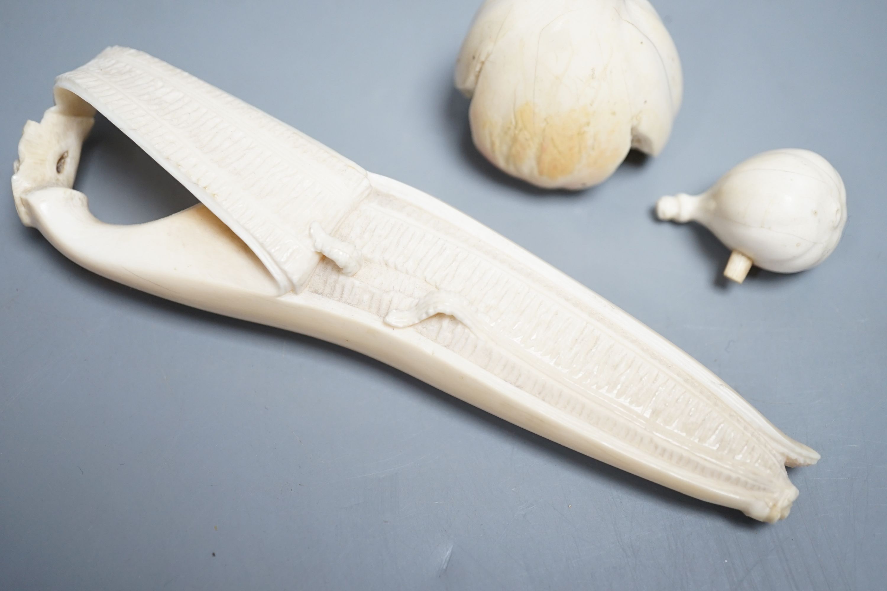 A Japanese ivory model of a partially peeled banana and an ivory model of figs, early 20th century (2) 15.5cm